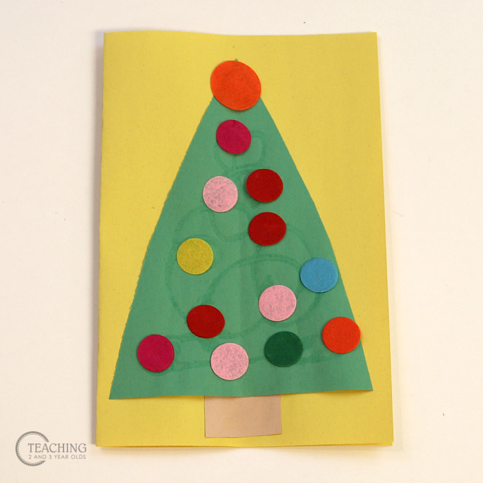 Put together a toddler Christmas card activity that also works fine motor skills as bright and cheerful felt circles are pressed onto a paper tree. Attach it to a handmade gift as a special touch!